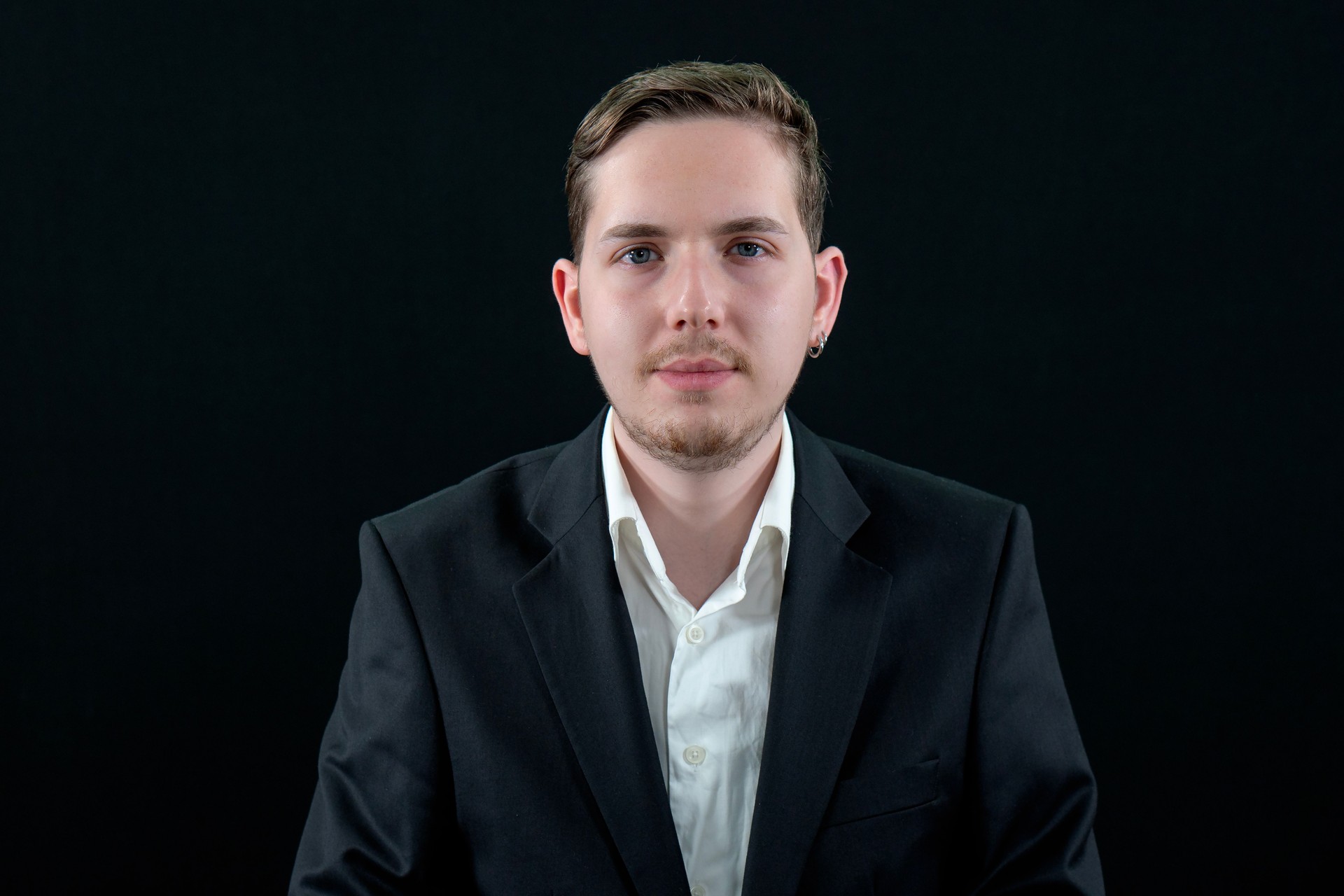 Confident in his business ability - smiling businessman in white shirt standing with isolated on black background.